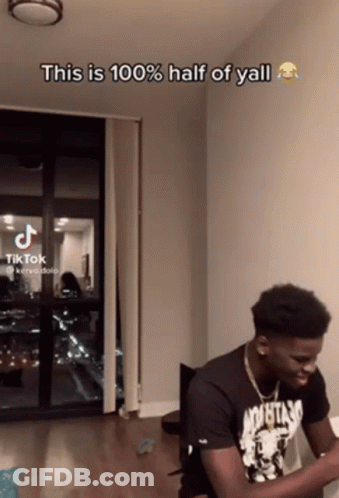 A Man Sitting In Front Of A Window With The Caption " This Is 100 % Half Of Y'all " GIF