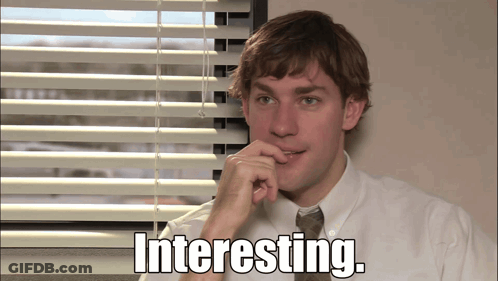 A Man Sitting In Front Of A Window With The Words Interesting Written On The Screen GIF