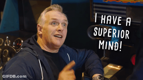 A Man Sitting In Front Of An Arcade Machine With The Words " I Have A Superior Mind " Above Him GIF