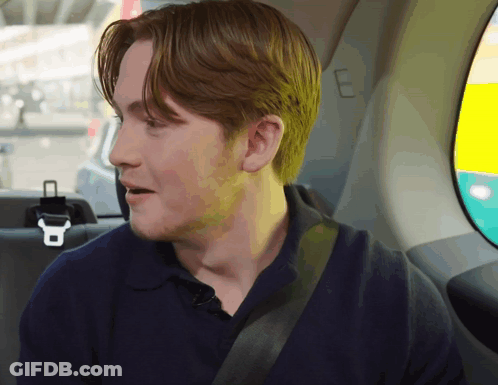 A Man Sitting In The Back Seat Of A Car GIF