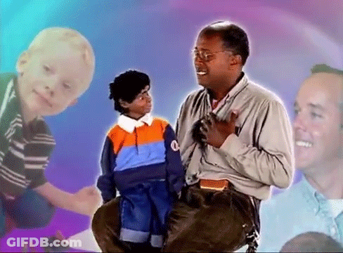 A Man Sitting Next To A Little Boy With The Letter Q On His Sweater GIF