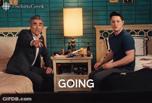 A Man Sitting On A Bed Next To Another Man Who Is Sitting On A Bed With The Word Going In Front Of Them GIF