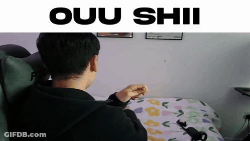 A Man Sitting On A Bed With The Words Ouu Shii Written Above Him GIF