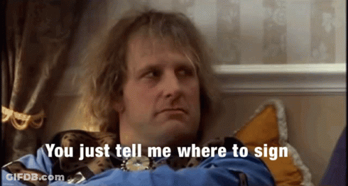 A Man Sitting On A Bed With The Words You Just Tell Me Where To Sign Behind Him GIF