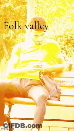 A Man Sitting On A Bench With The Word Folk Valley Written On The Bottom GIF