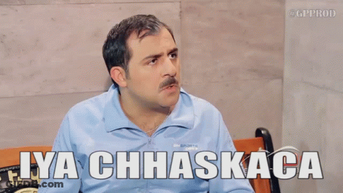 A Man Sitting On A Bench With The Words Iya Chhaskaca Above Him GIF