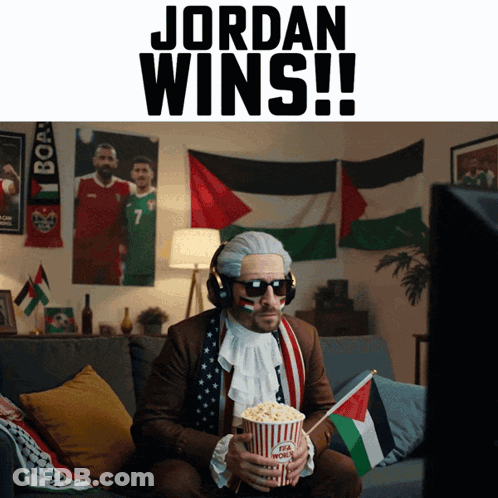 A Man Sitting On A Couch Holding A Popcorn Bucket With The Words Jordan Wins Below Him GIF
