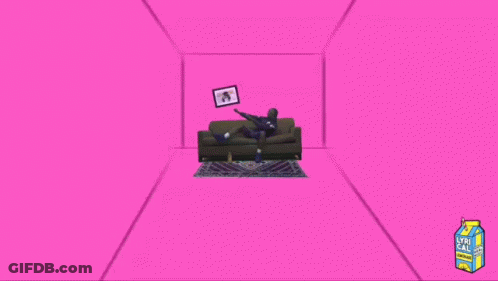 A Man Sitting On A Couch Next To A Box Of Lyri Cax GIF