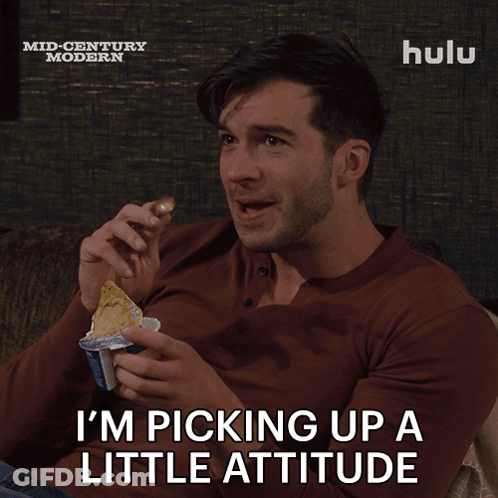 A Man Sitting On A Couch With A Hulu Logo On The Bottom Right GIF