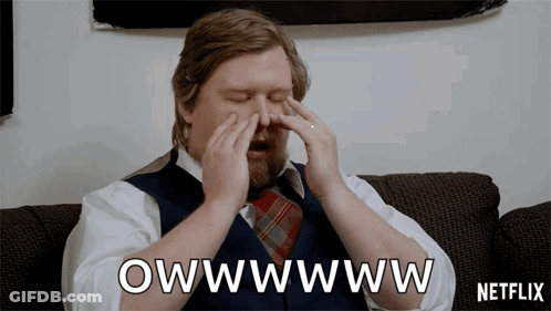A Man Sitting On A Couch With His Eyes Closed And A Netflix Logo In The Background GIF