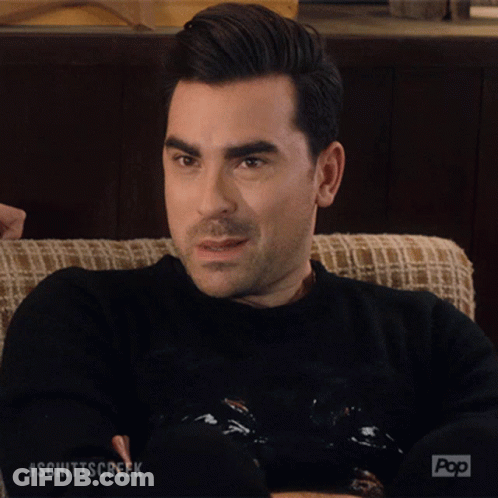 A Man Sitting On A Couch With His Eyes Closed And The Word Okay Written On His Face GIF
