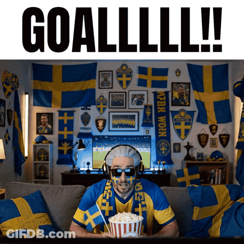 A Man Sitting On A Couch With Popcorn And A Scarf That Says ' Sven ' On It GIF