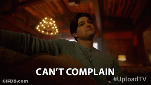 A Man Sitting On A Couch With The Words Can 'T Complain GIF