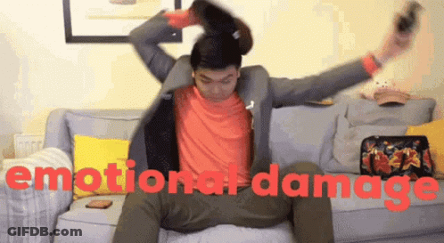 A Man Sitting On A Couch With The Words Emotional Damage Written On The Bottom GIF