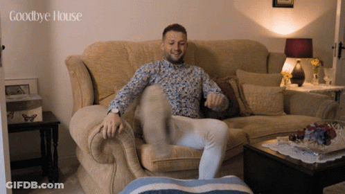 A Man Sitting On A Couch With The Words Goodbye House Written Above Him GIF