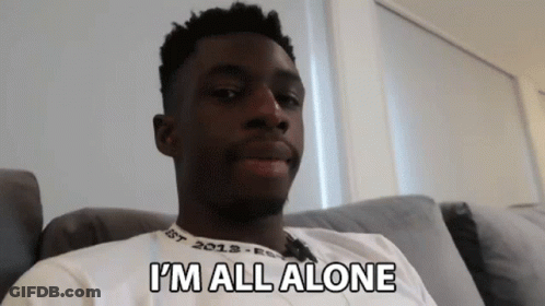 A Man Sitting On A Couch With The Words I 'M All Alone Written On His Shirt GIF