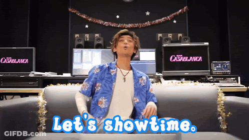 A Man Sitting On A Couch With The Words Let 'S Showtime GIF