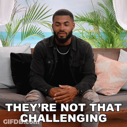 A Man Sitting On A Couch With The Words " They 'Re Not That Challenging " GIF