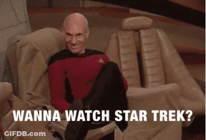 A Man Sitting On A Couch With The Words " Wanna Watch Star Trek " Written Below Him GIF