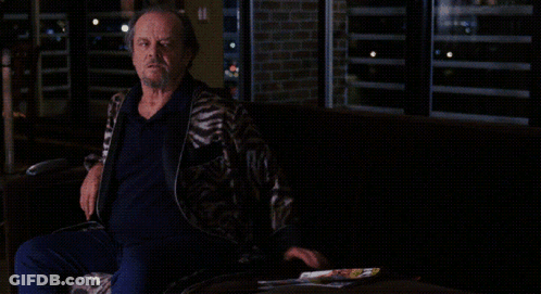 A Man Sitting On A Couch With The Words Watch Your F * * Kin Mouth On The Bottom GIF