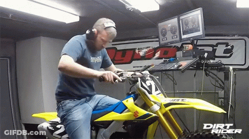A Man Sitting On A Dirt Bike With The Number 12 On The Front GIF