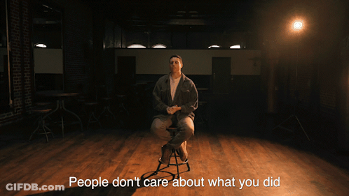 A Man Sitting On A Stool With The Words " They Want To Know What You 'Re Going To Do Next " GIF