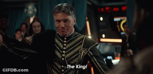 A Man Sitting On A Throne With The Words " The King " Written On It GIF