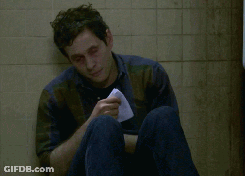 A Man Sitting On The Floor With A Napkin In His Hand And The Words I Think I Might Be Coming Down GIF