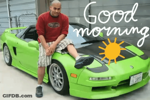A Man Sitting On The Hood Of A Green Sports Car With The Words Good Morning Written On The Bottom GIF