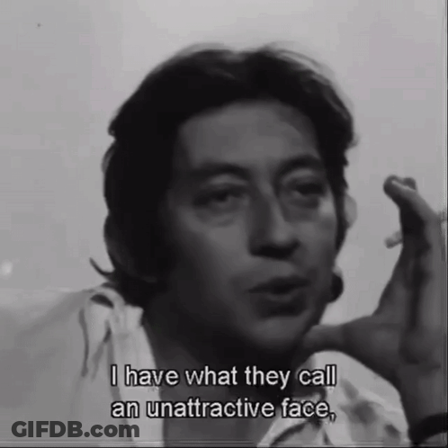 A Man Smoking A Cigarette And Saying " I Have What They Call An Unattractive Face " GIF