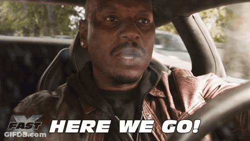 A Man Smoking A Cigarette In A Car With The Words Here We Go Below Him GIF