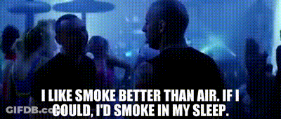 A Man Smoking A Cigarette In Front Of A Crowd Of People With The Words I Like Smoke Better Than Air GIF
