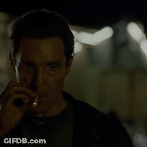 A Man Smoking A Cigarette In The Dark GIF