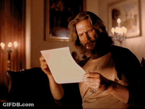 A Man Smoking A Cigarette While Reading A Letter GIF