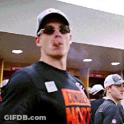 A Man Smoking A Cigarette While Wearing Sunglasses And A Chicago T-Shirt GIF