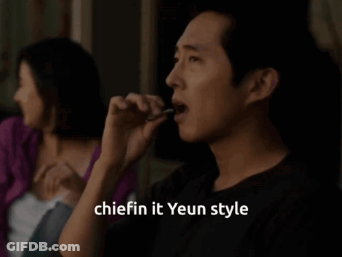 A Man Smoking A Cigarette With The Words " Chiefin It Yeun Style " Written Below Him GIF