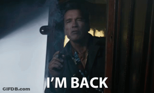 A Man Smoking A Cigarette With The Words I 'M Back Written Below Him GIF