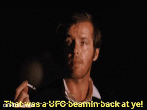 A Man Smoking A Cigarette With The Words " That Was A Ufo Beamin Back At Ye " Behind Him GIF