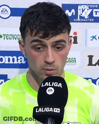 A Man Speaking Into A Laliga Tv Microphone While Wearing A Green Jersey GIF