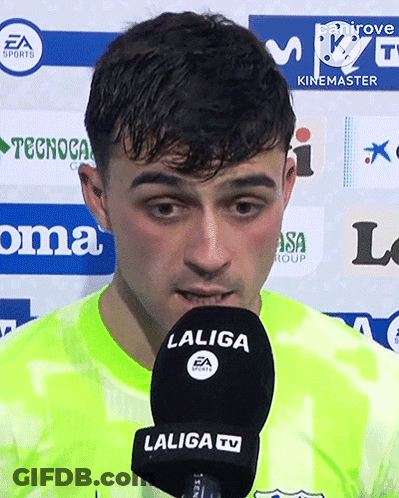 A Man Speaking Into A Laliga Tv Microphone While Wearing A Neon Green Shirt GIF