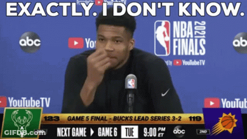 A Man Speaking Into A Microphone In Front Of A Screen That Says Nba Finals GIF