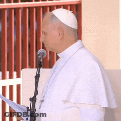 A Man Speaking Into A Microphone While Wearing A White Hat GIF