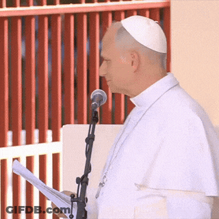 A Man Speaking Into A Microphone While Wearing A White Hat GIF