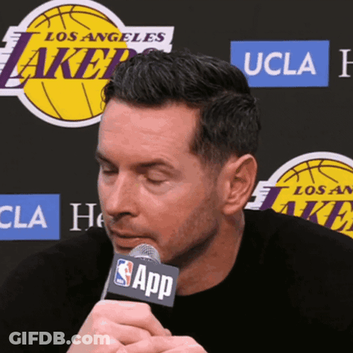 A Man Speaking Into A Microphone With The Word App On It GIF