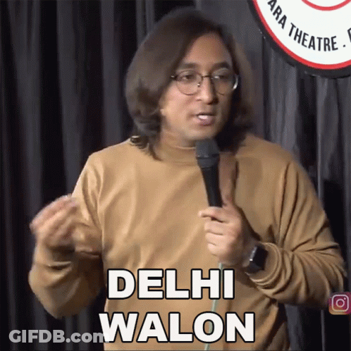A Man Speaking Into A Microphone With The Words Delhi Walon Above Him GIF
