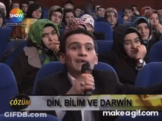 A Man Speaking Into A Microphone With The Words Din Bilim Ve Darwin On The Screen GIF