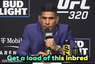 A Man Speaking Into A Microphone With The Words Get A Load Of This Inbreed Written Below Him GIF