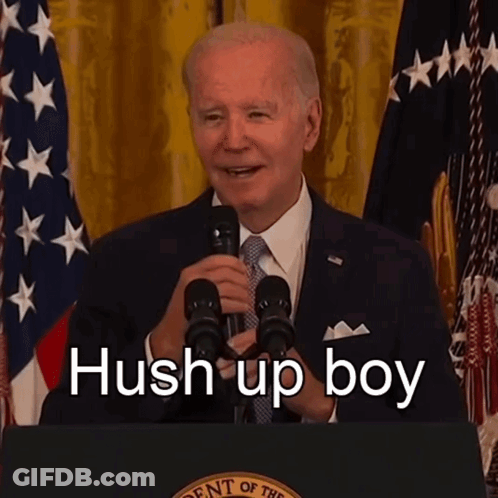 A Man Speaking Into A Microphone With The Words Hush Up Boy Written On The Bottom GIF