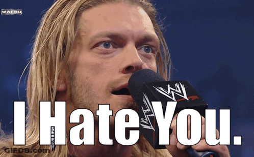 A Man Speaking Into A Microphone With The Words I Hate You Behind Him GIF
