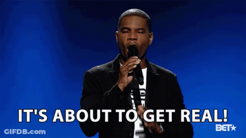 A Man Speaking Into A Microphone With The Words It 'S About To Get Real Behind Him GIF
